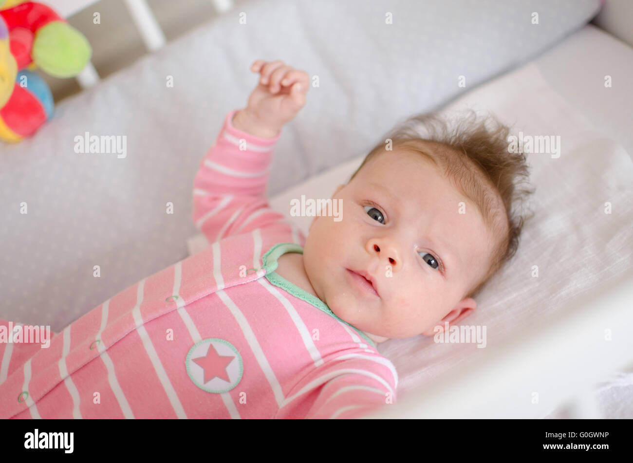 baby in a cot Stock Photo Alamy