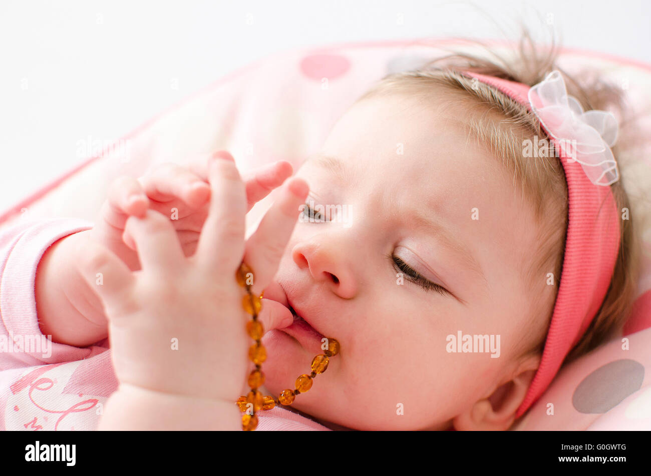 teething baby girl Stock Photo