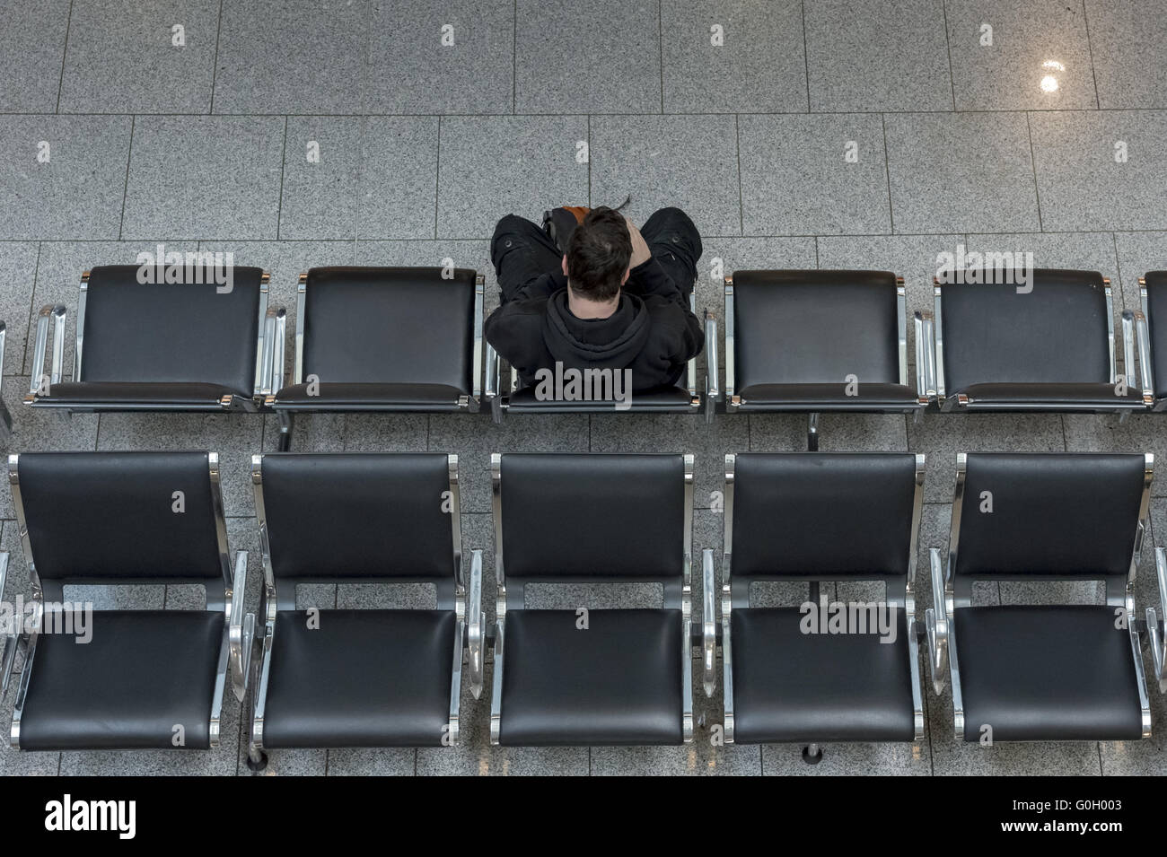 A single man is centered on a chair in a double row. Top view and rear view. Stock Photo