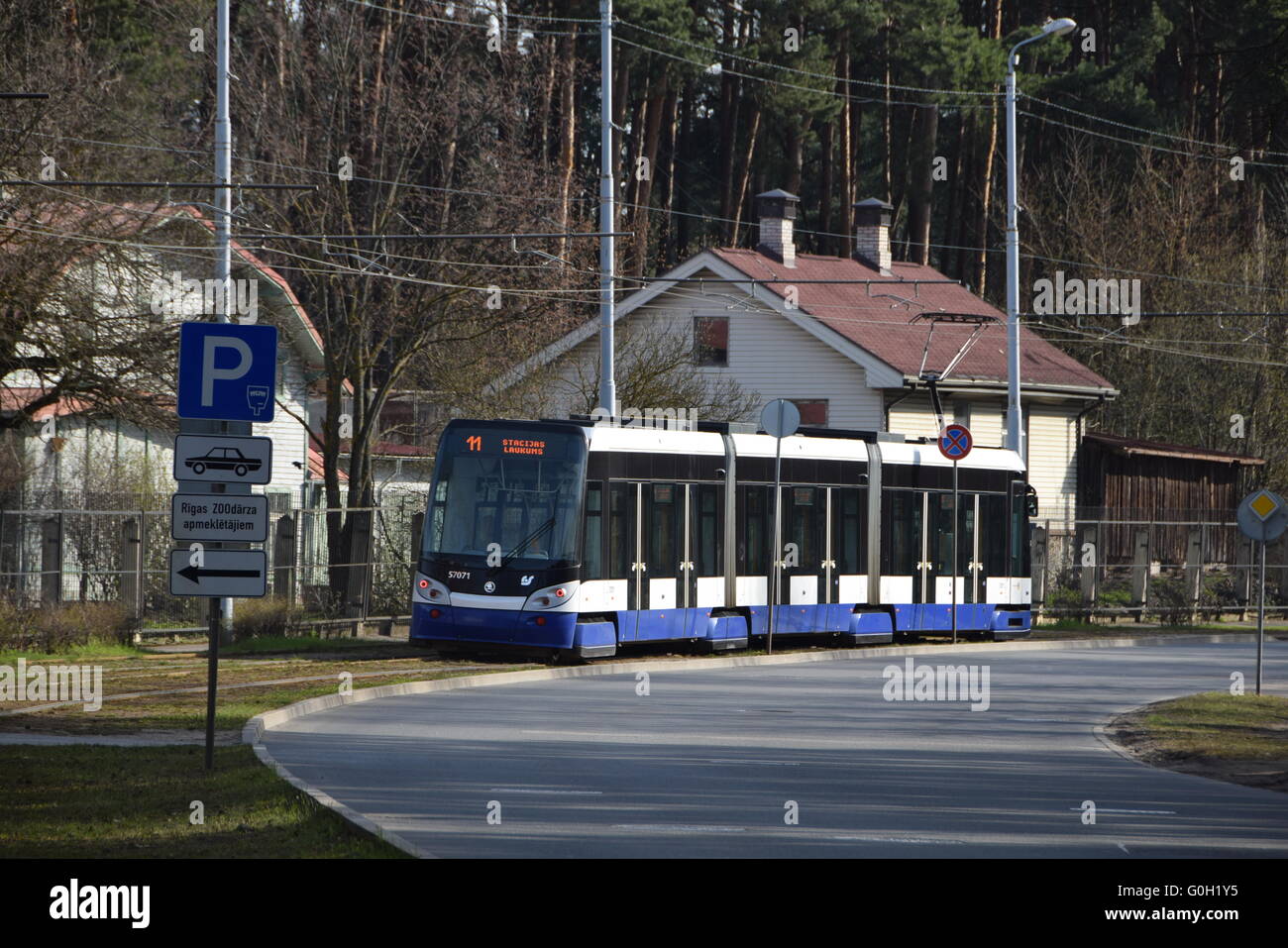 Riga tram in city surrounds: track layout, stops arrangement and famous trolley pole current collection Stock Photo