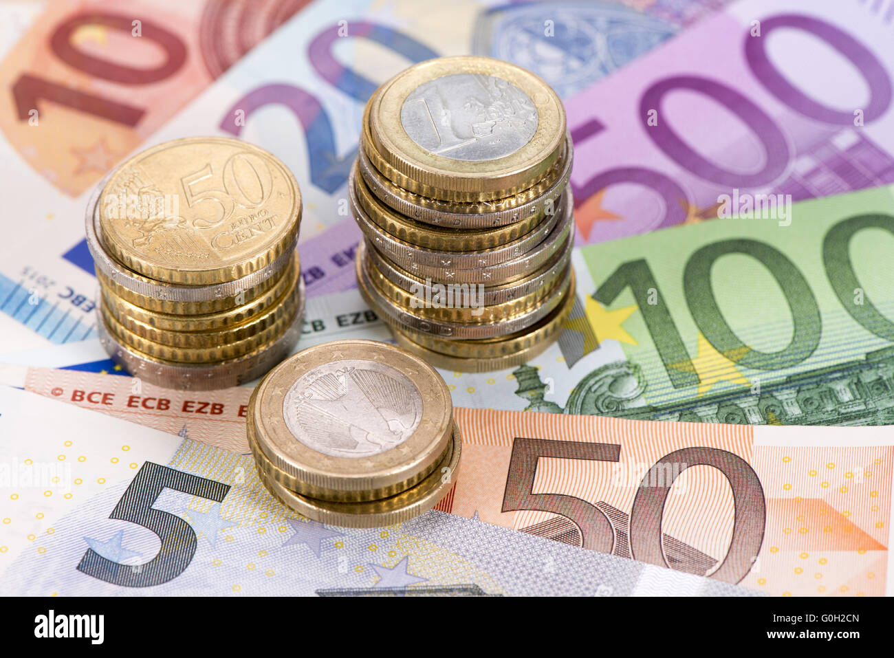 stack of euro coins on banknotes Stock Photo