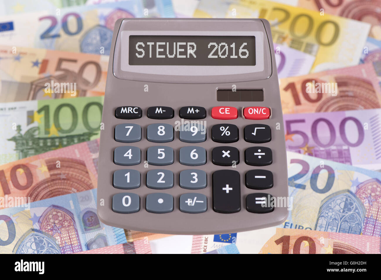 financial calculator with display 2016 on euro banknotes Stock Photo