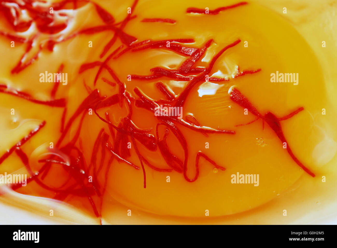 Raw egg with saffron Stock Photo - Alamy