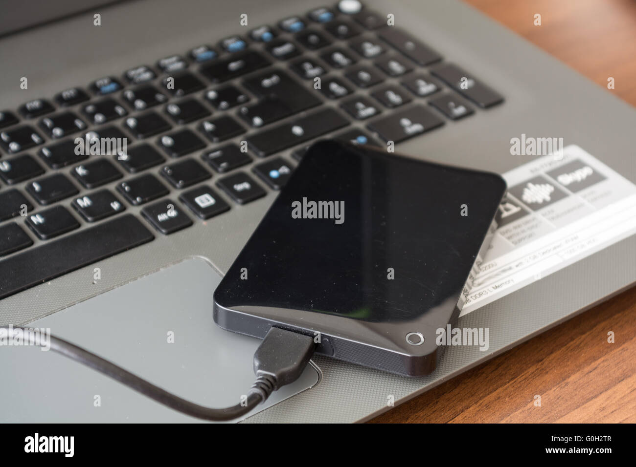 external hard drive is connected to laptop for backup - Closeup Stock Photo