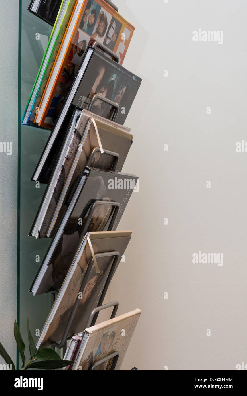 modern magazine rack offers clear selection of books Stock Photo