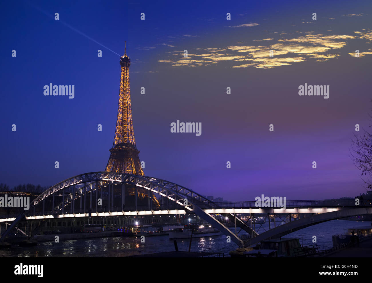 Eiffel Tower illuminated and the bridge Passerelle Debilly, view from