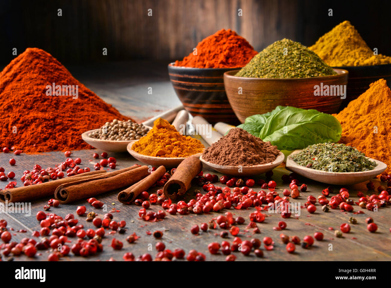 Variety of spices on kitchen table Stock Photo - Alamy