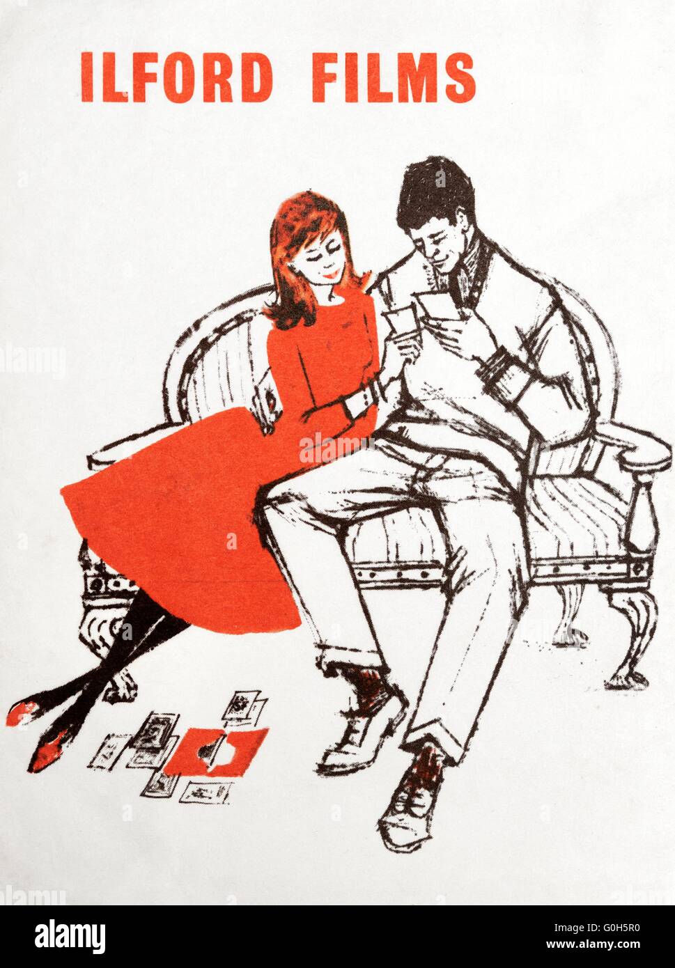 The front of an old ILFORD films photograph envelope with an illustration of  a couple looking at some photographs Stock Photo