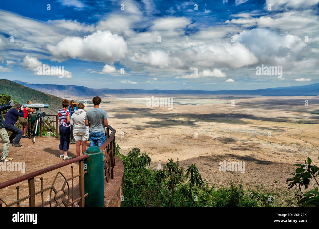 tourists with huge binocular looking from the rim into the Ngorongoro crater, UNESCO world heritage site, Tanzania, Africa Stock Photo