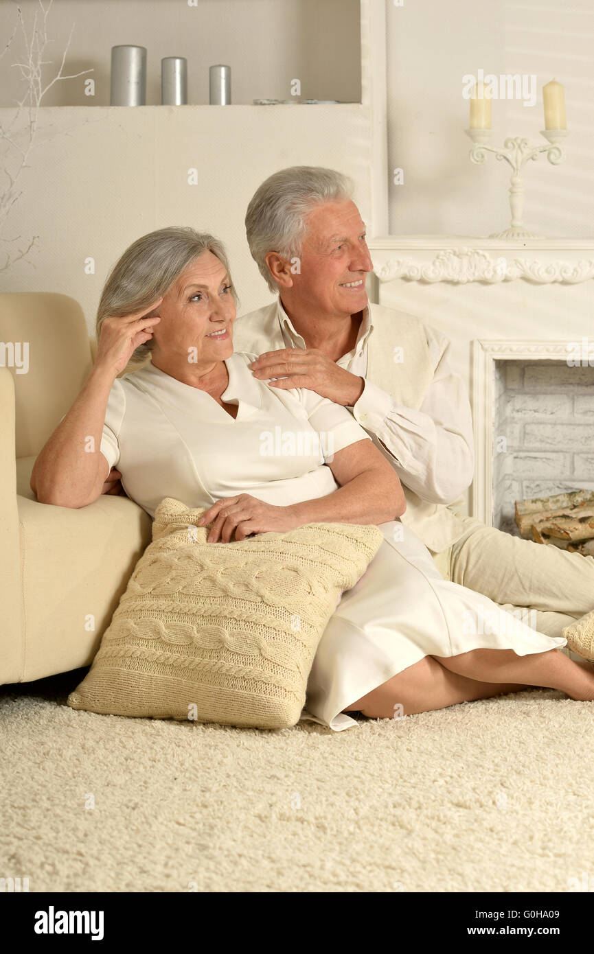 Elderly people sitting near  couch Stock Photo