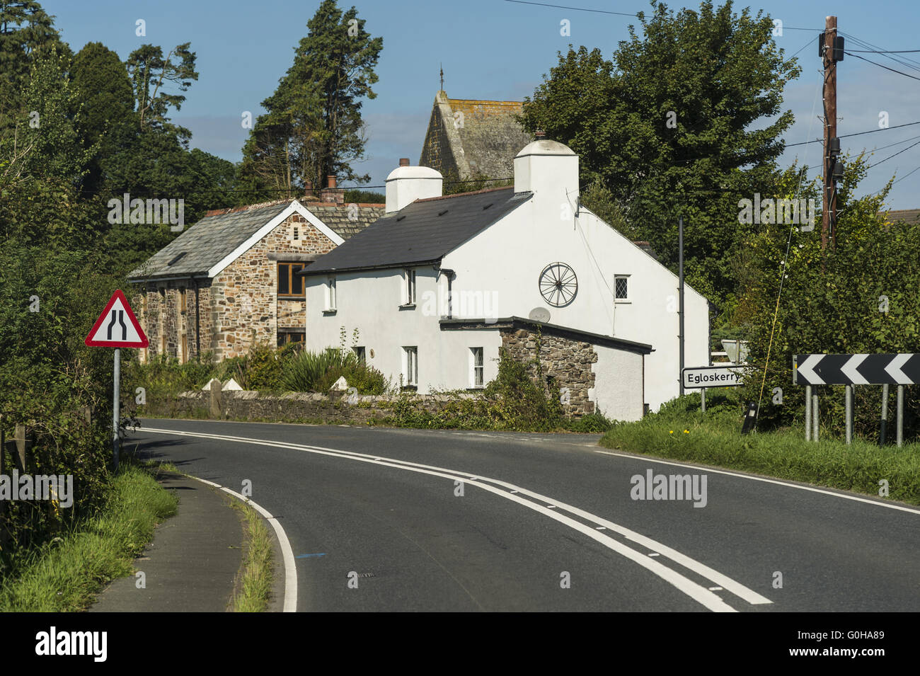 Curve and road narrowing at the tunnel entrance to Egloskerry. Stock Photo