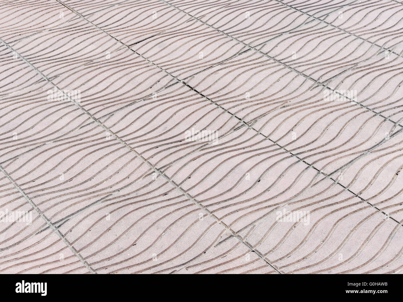Wave pattern of stone tile on the pavement in urban park. Stock Photo
