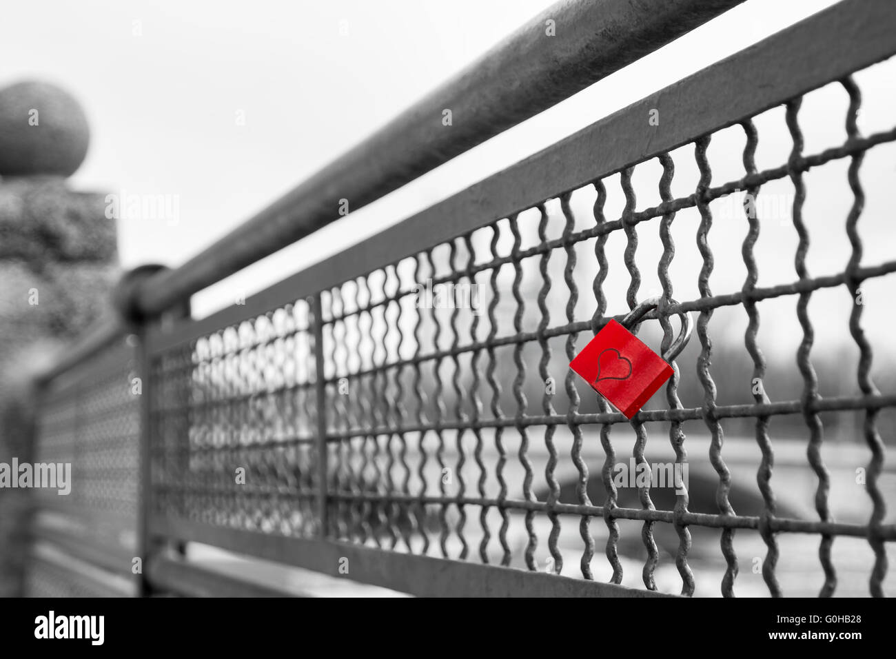 Red love lock padlock with heart on bridge symbol of true eternal love and commitment Stock Photo