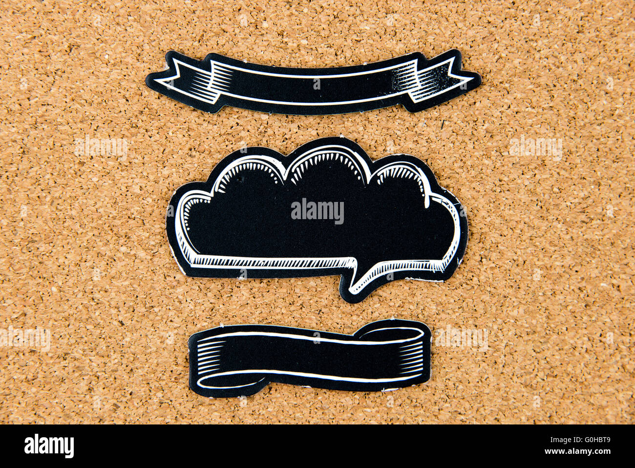 Slp Ribbons Empty black speech ribbons over cork board background, copy space ...