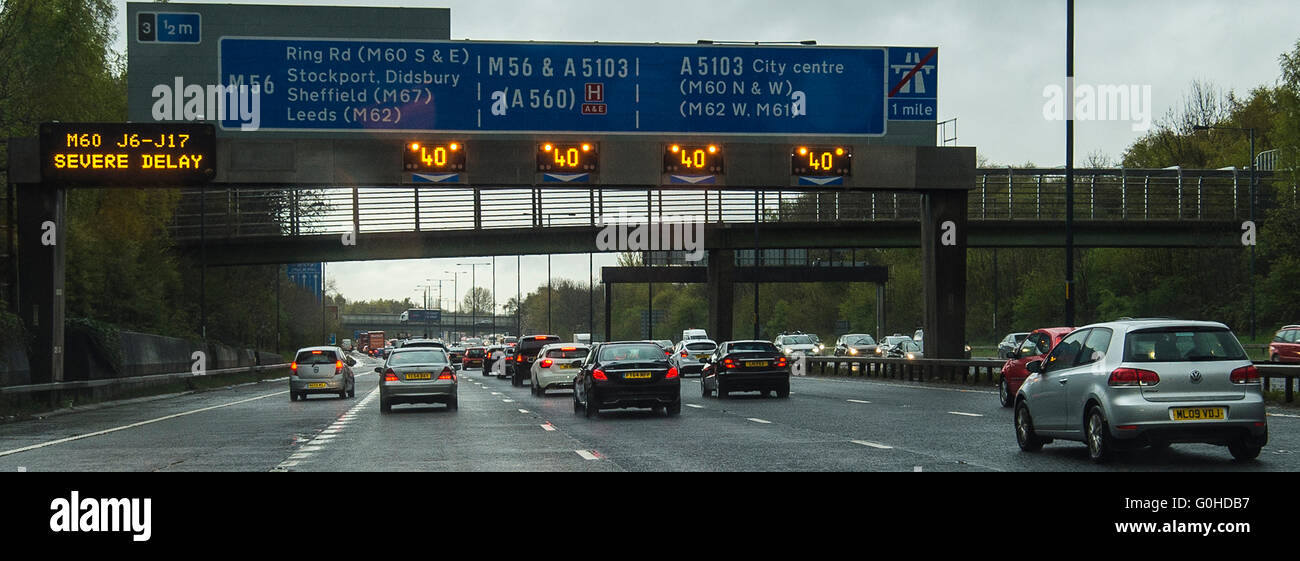 Traffic jam on motorway with gantry matrix sign displaying Severe Delay Stock Photo