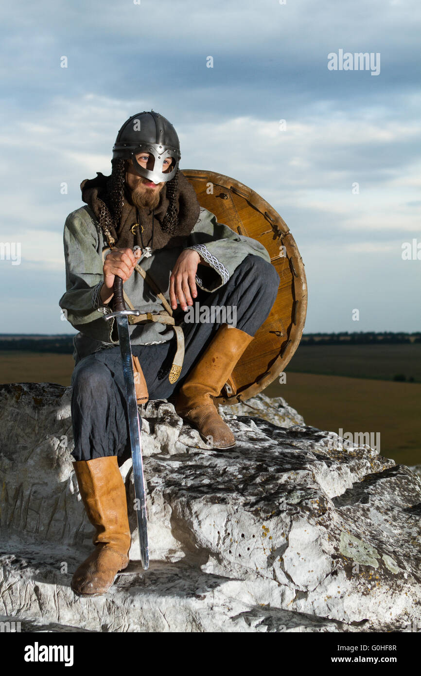 Siting Knight Knight sitting on a rock with a sword Stock Photo - Alamy