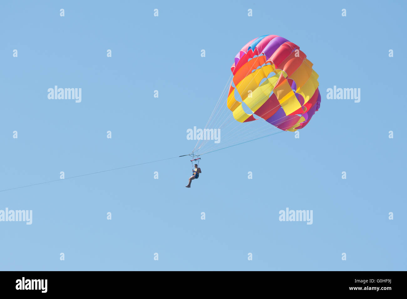 Man floating in the sky on a parachute Stock Photo