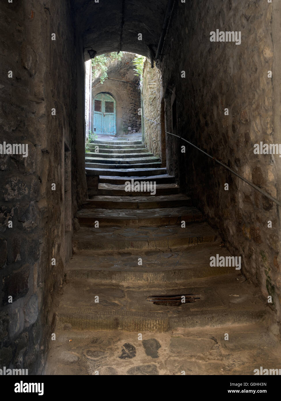 Cobwebbed, forgotten old doorway up dark alley. Stock Photo