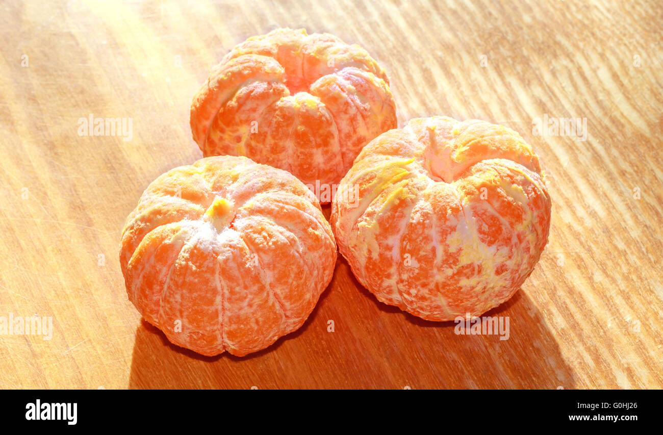Three peeled tangerines Stock Photo Alamy