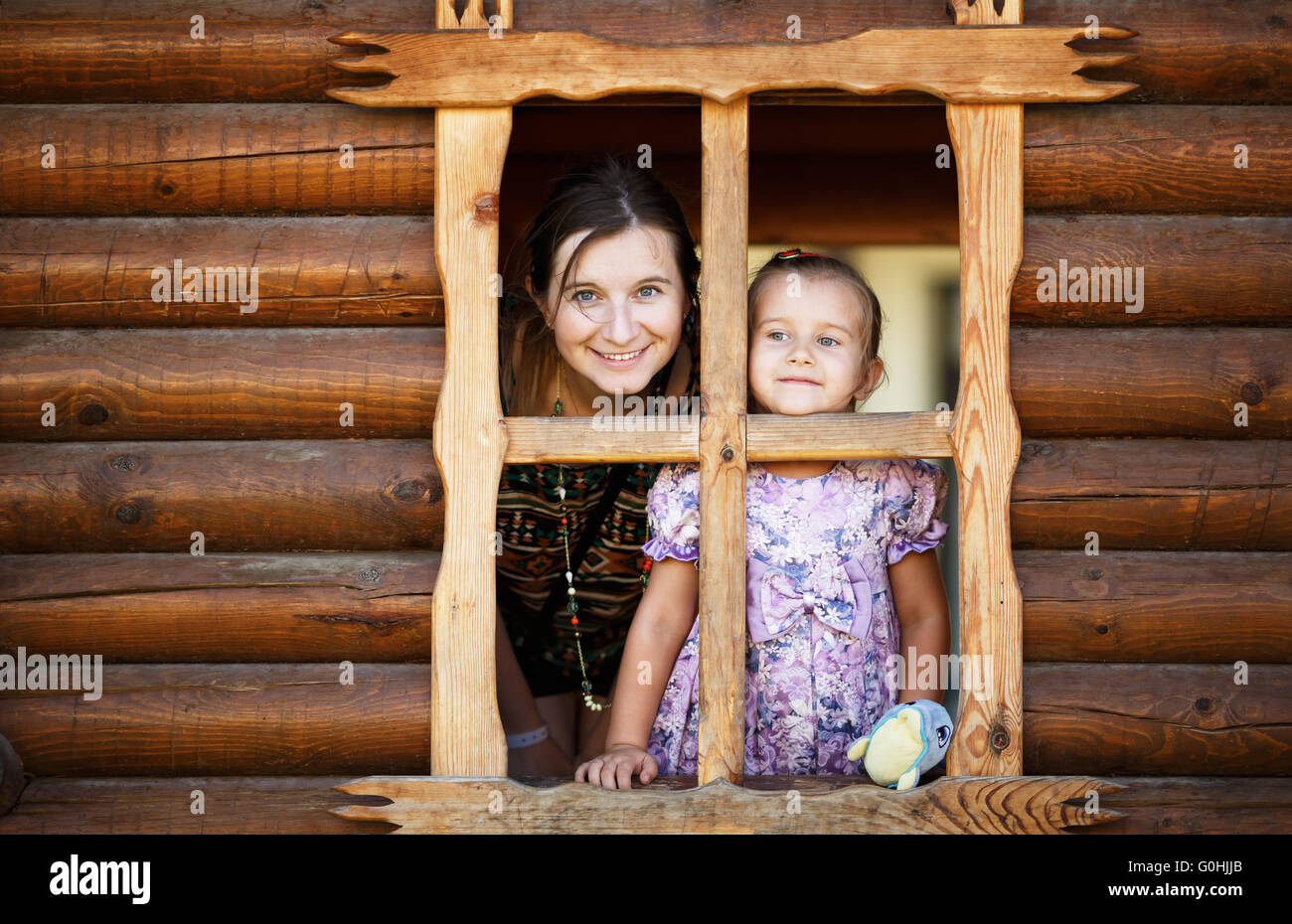 Mom And Daughter In The Window Stock Photo Alamy