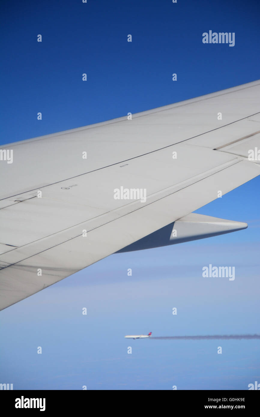The wing of a commercial jetliner, mid flight Stock Photo