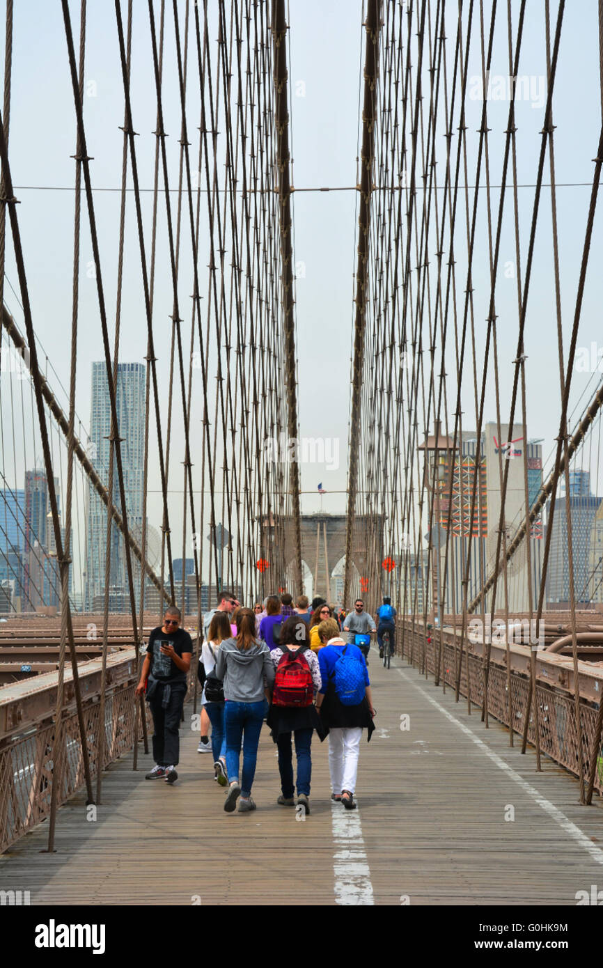People walking across the Brooklyn Bridge,New York City, USA Stock