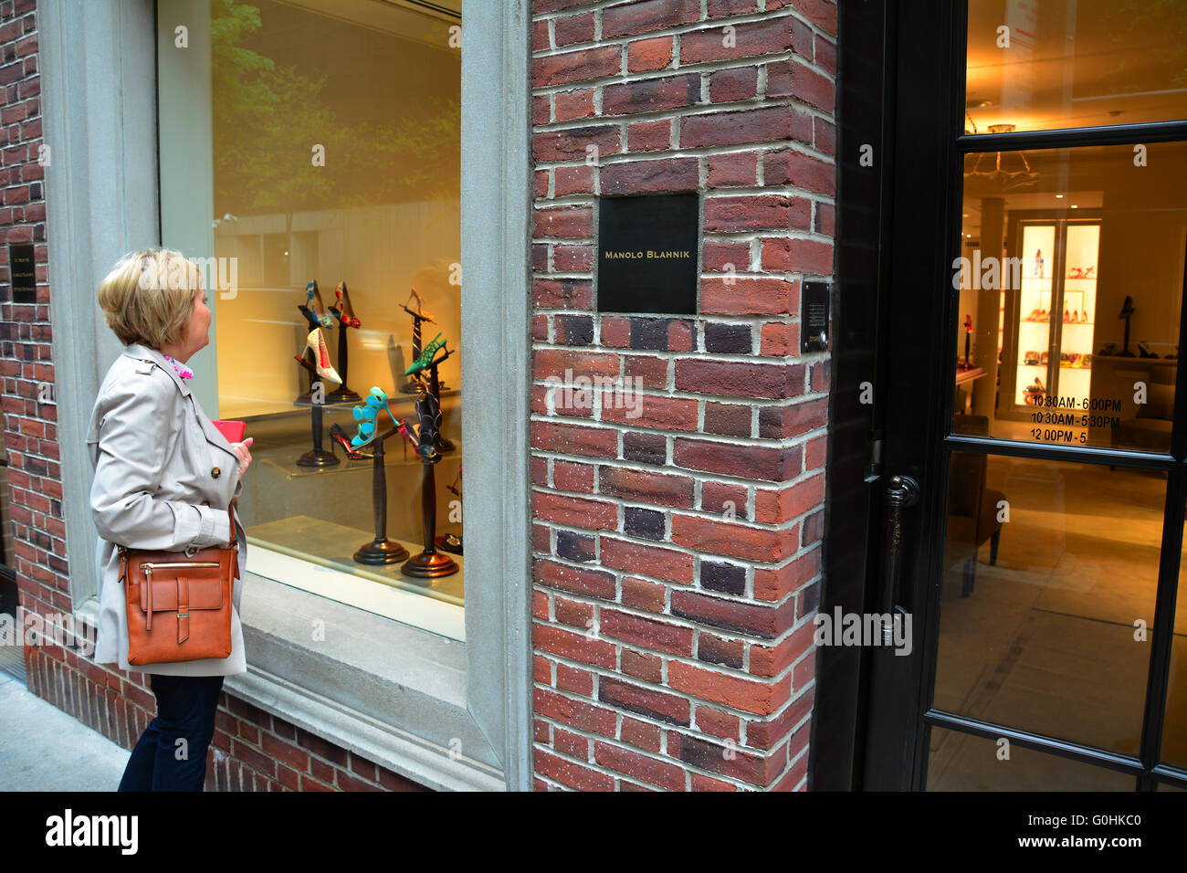 A woman looking in the window of Manolo Blahnik, New York City Stock Photo