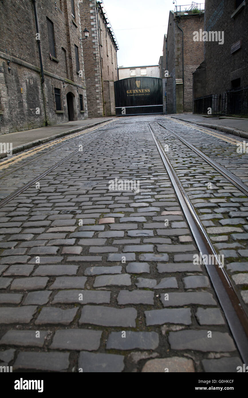Original Cobblestone streets outside the Guinness Storehouse brewery in Dublin Ireland with old tram lines Stock Photo
