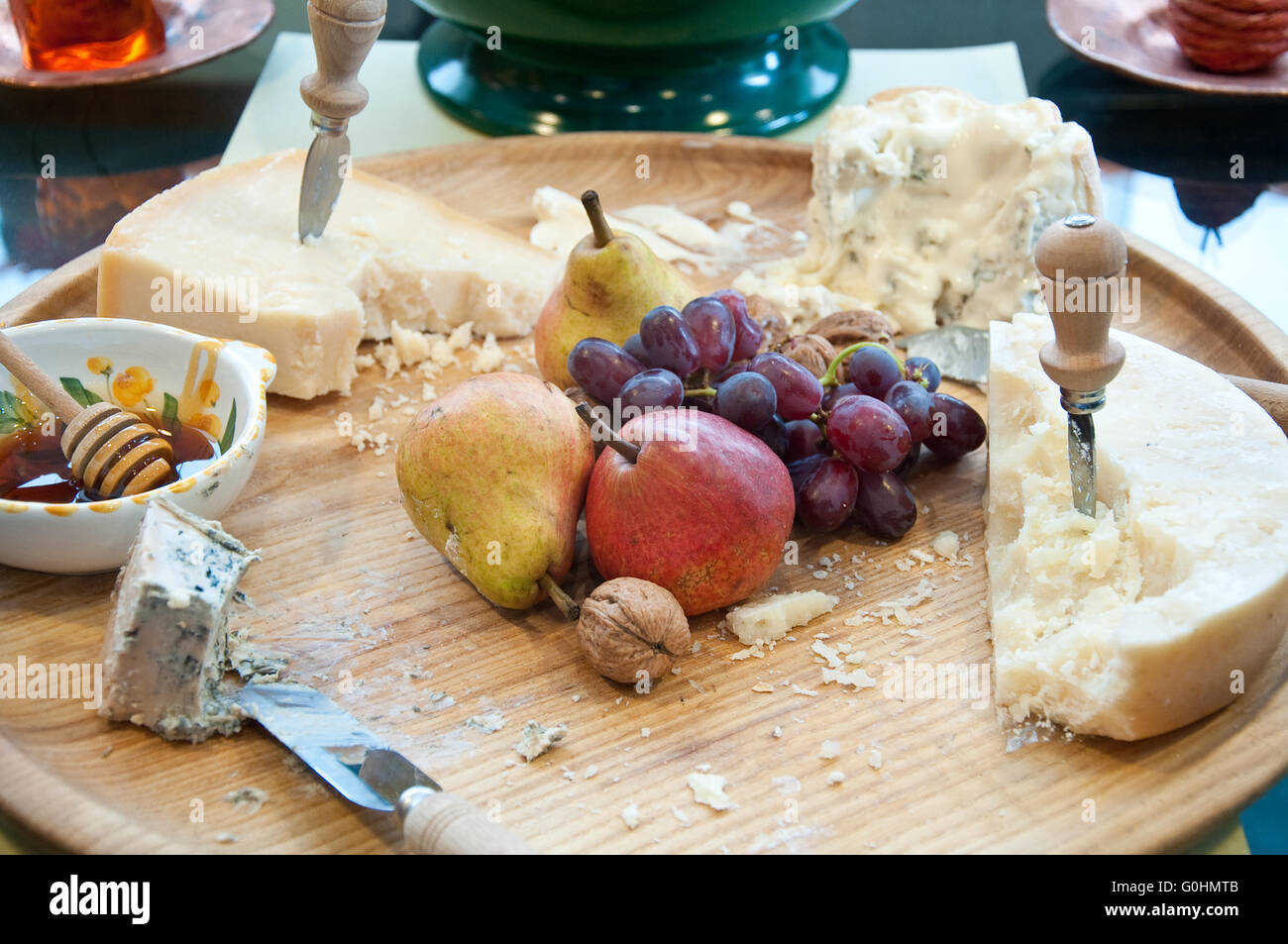 Different types of Italian cheeses served with honey and fruits,italy Stock Photo