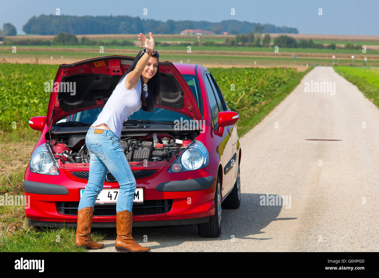 Woman has in her car breaks down. Engine failure Stock Photo - Alamy