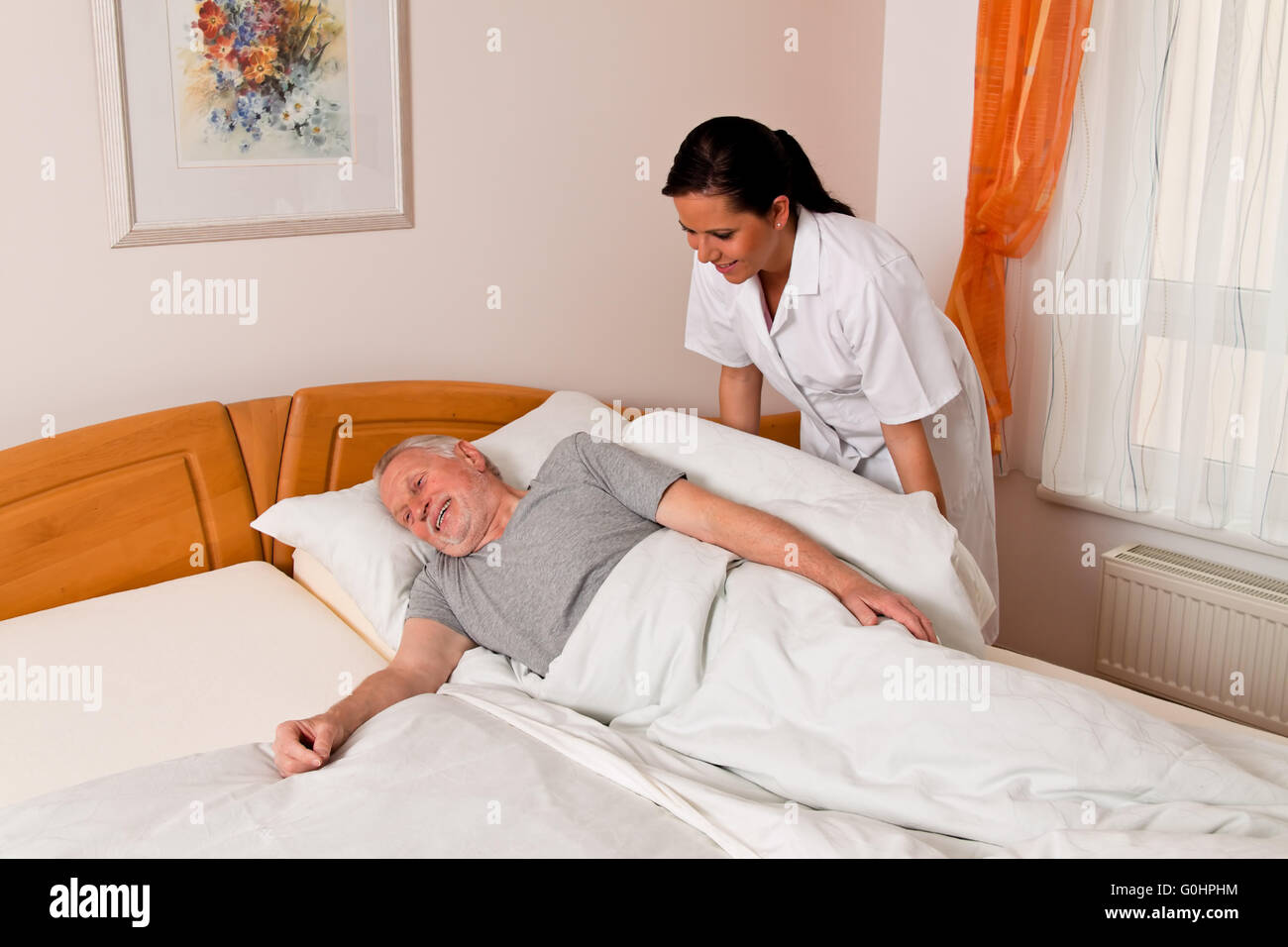 Nurse in aged care for the elderly in nursing homes Stock Photo