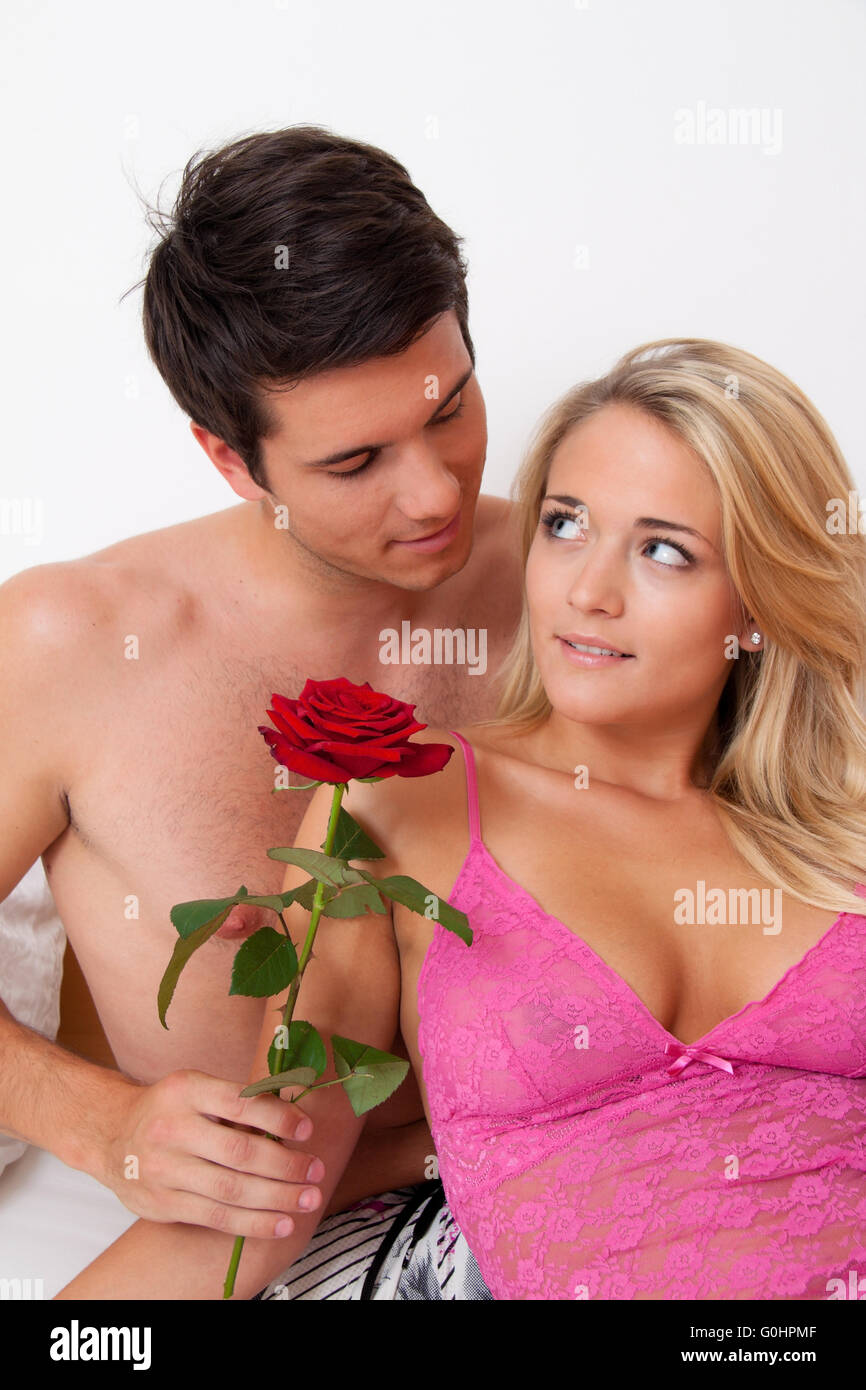 Romantic couple in bed with Rose. Marry the man. Stock Photo