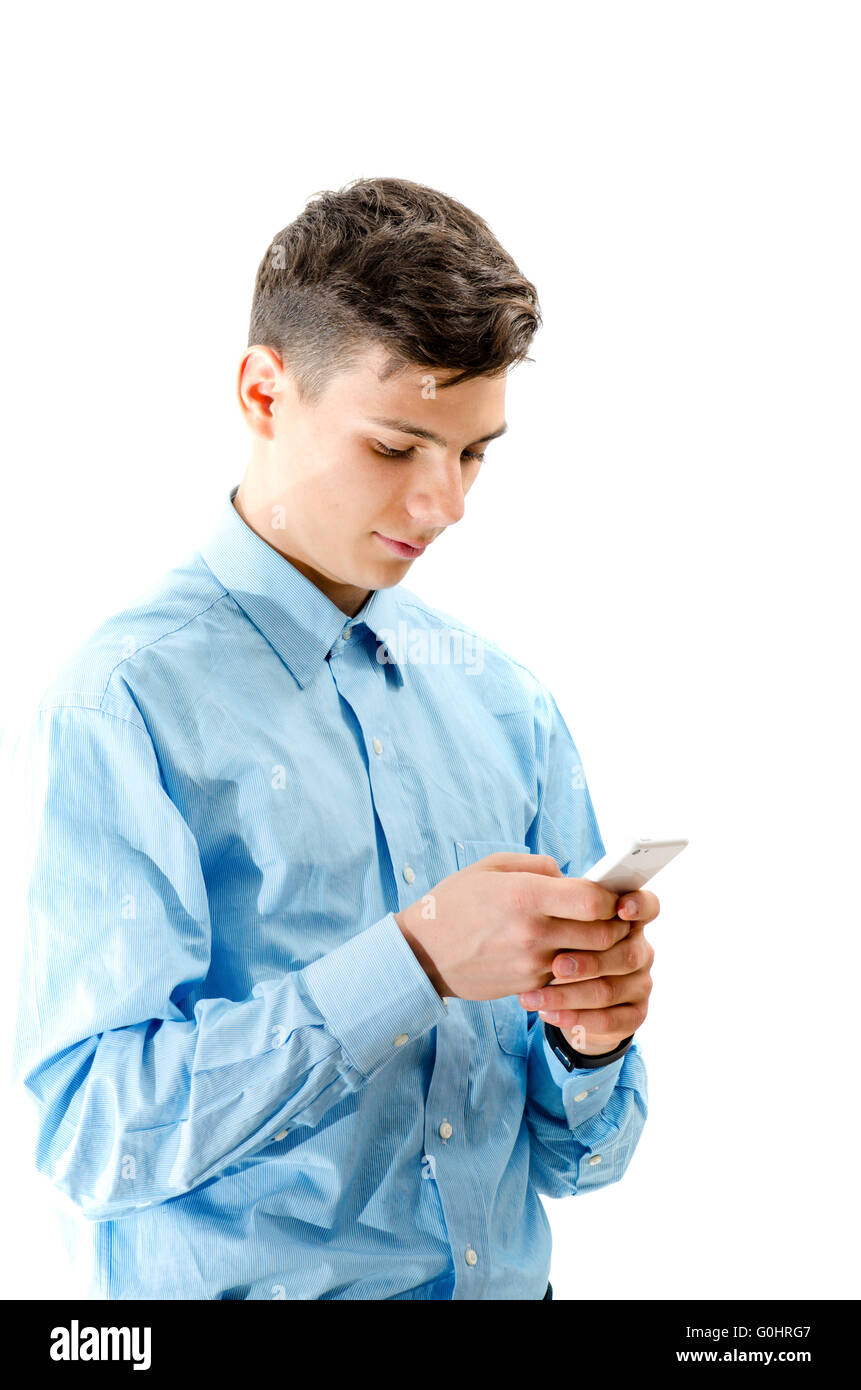 Trendy teenager boy texting on white smartphone isolated on white Stock Photo