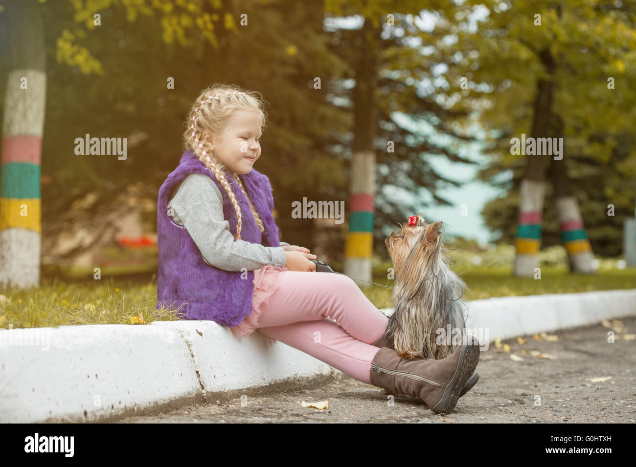 Image of cute little girl playing with dog in park Stock Photo - Alamy