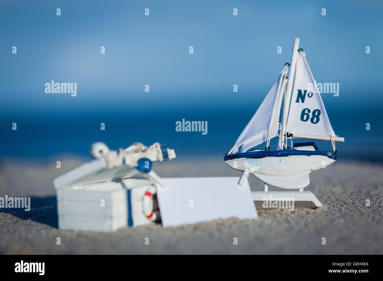 sailing boat and seashell in sand decoration closeup Stock Photo