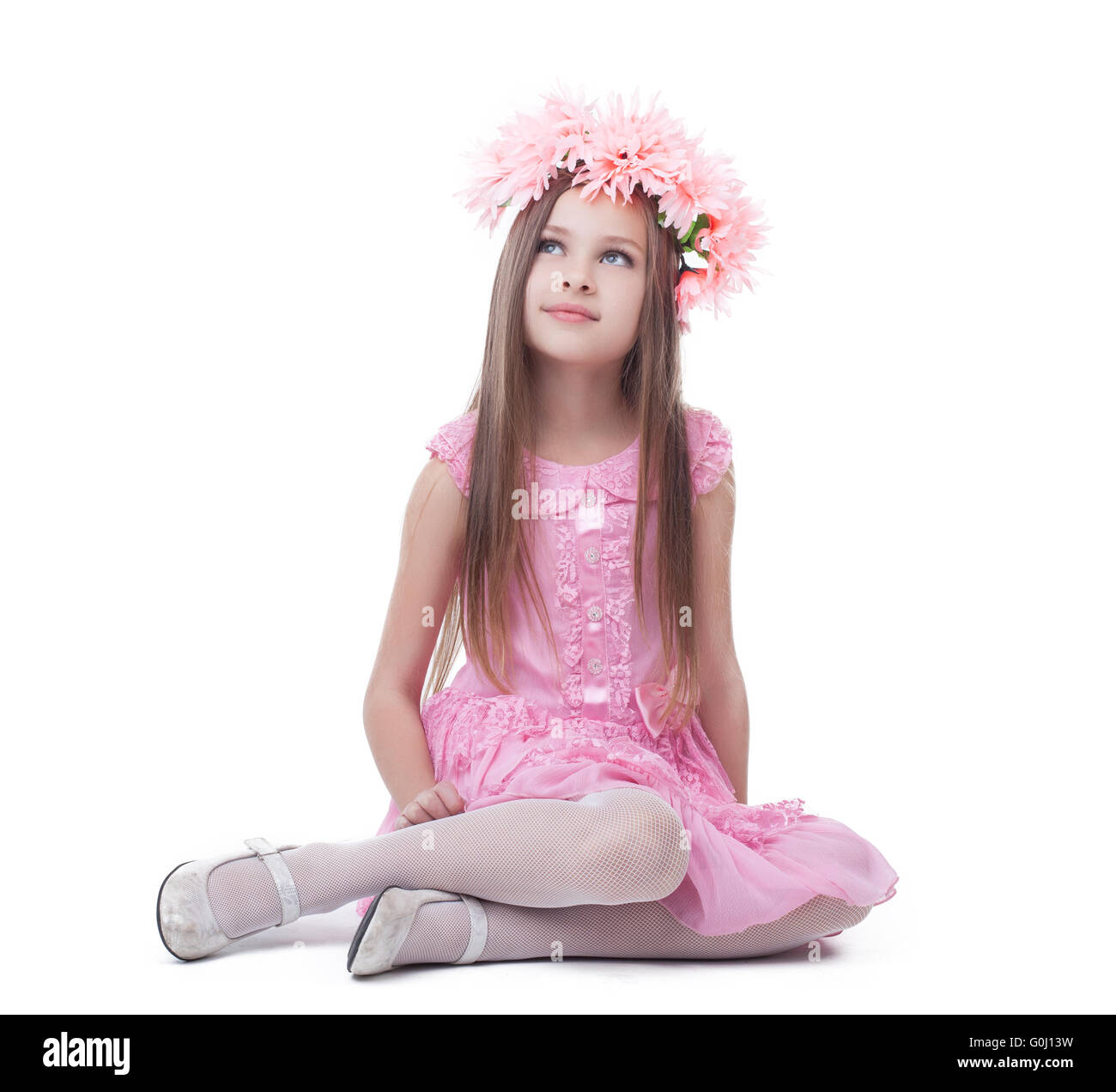 Little girl in pink dress and wreath sitting Stock Photo - Alamy
