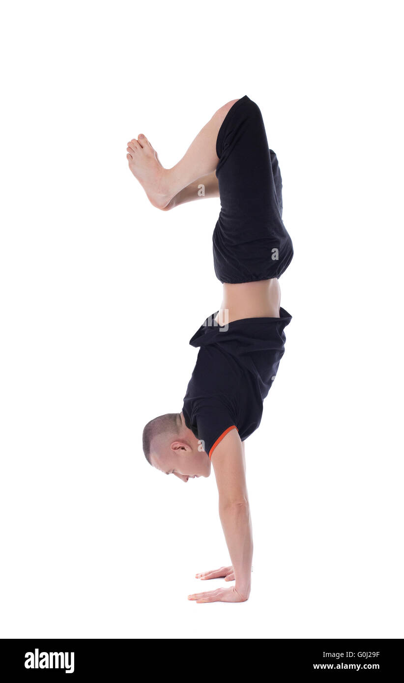 Athletic man doing handstand, isolated on white Stock Photo
