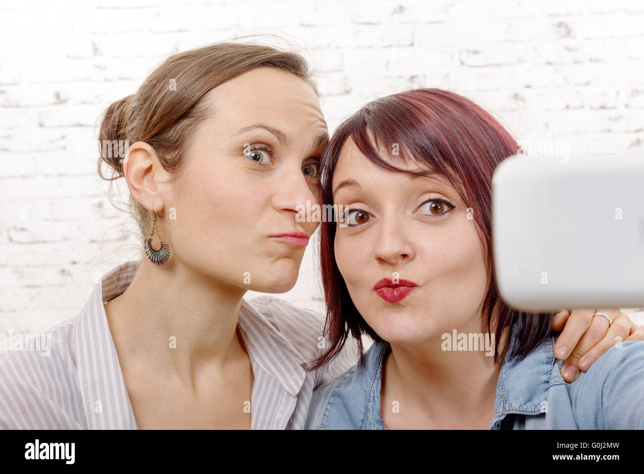 Two young funny women taking a selfie Stock Photo Alamy