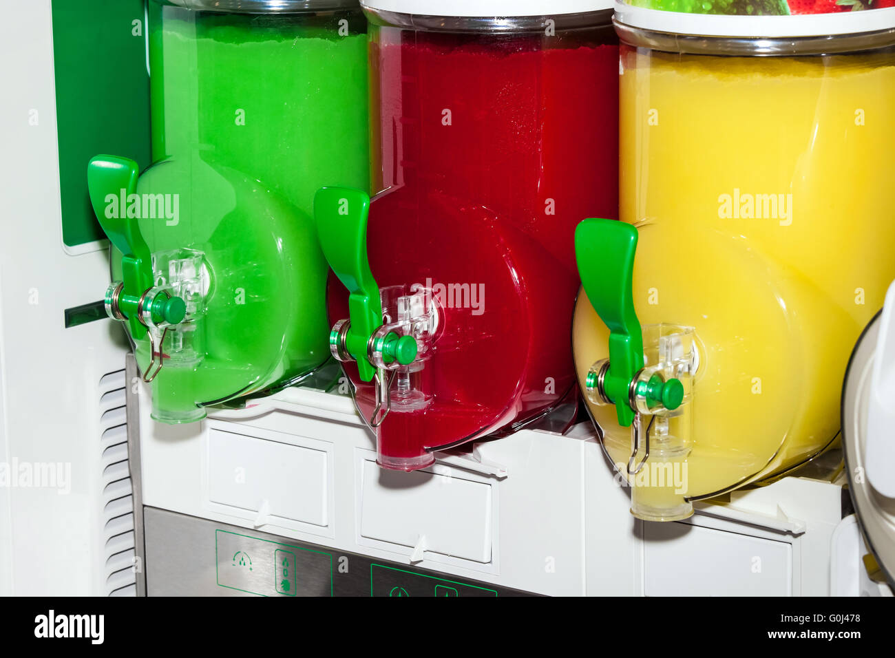 Three moist juice machines in action. Frozen drink dispenser Stock Photo
