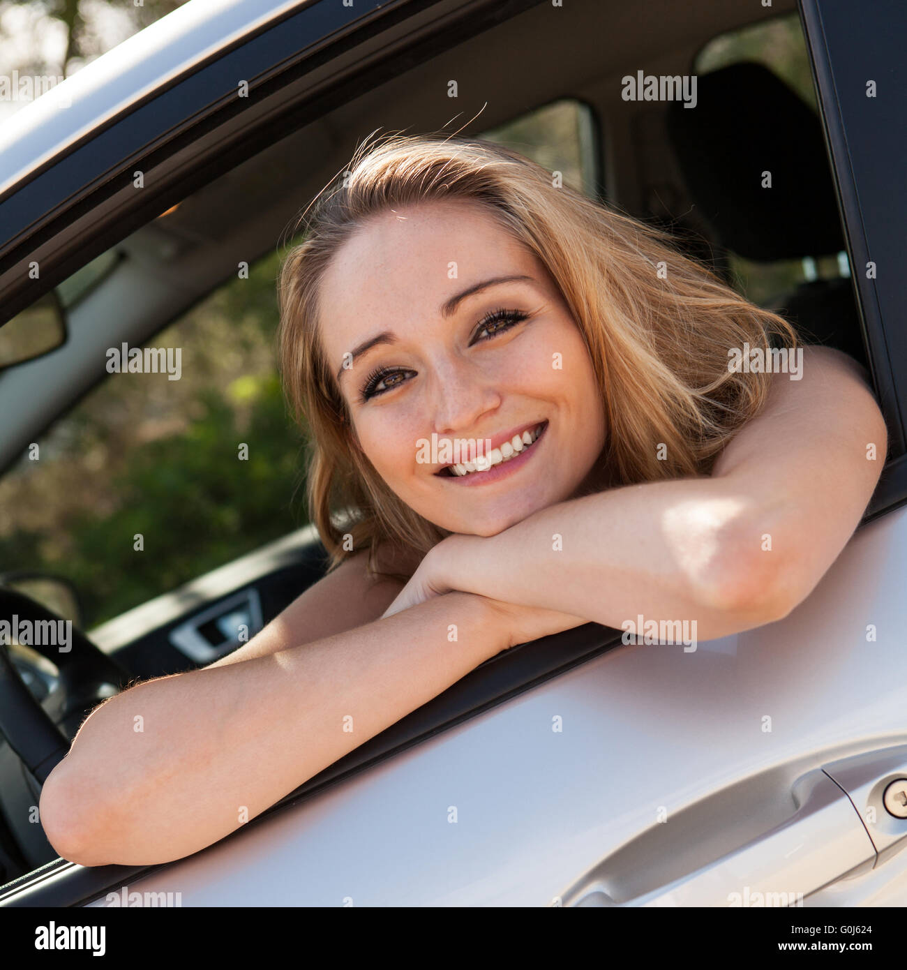 young attractive happy woman sitting in car summertime Stock Photo - Alamy