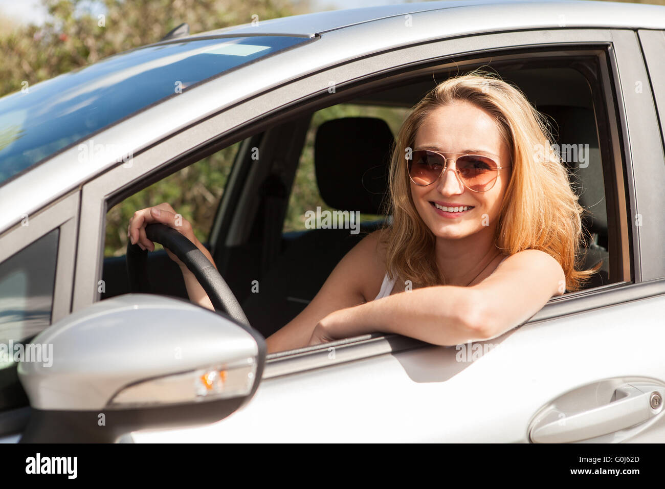 young attractive happy woman sitting in car summertime Stock Photo - Alamy