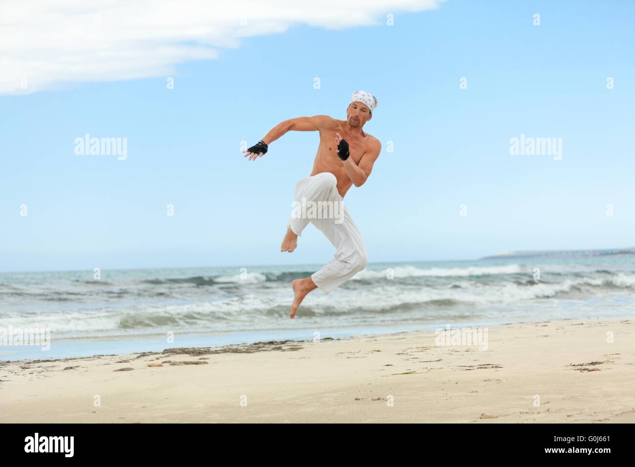 man is jumping sport karate martial arts fight kick Stock Photo