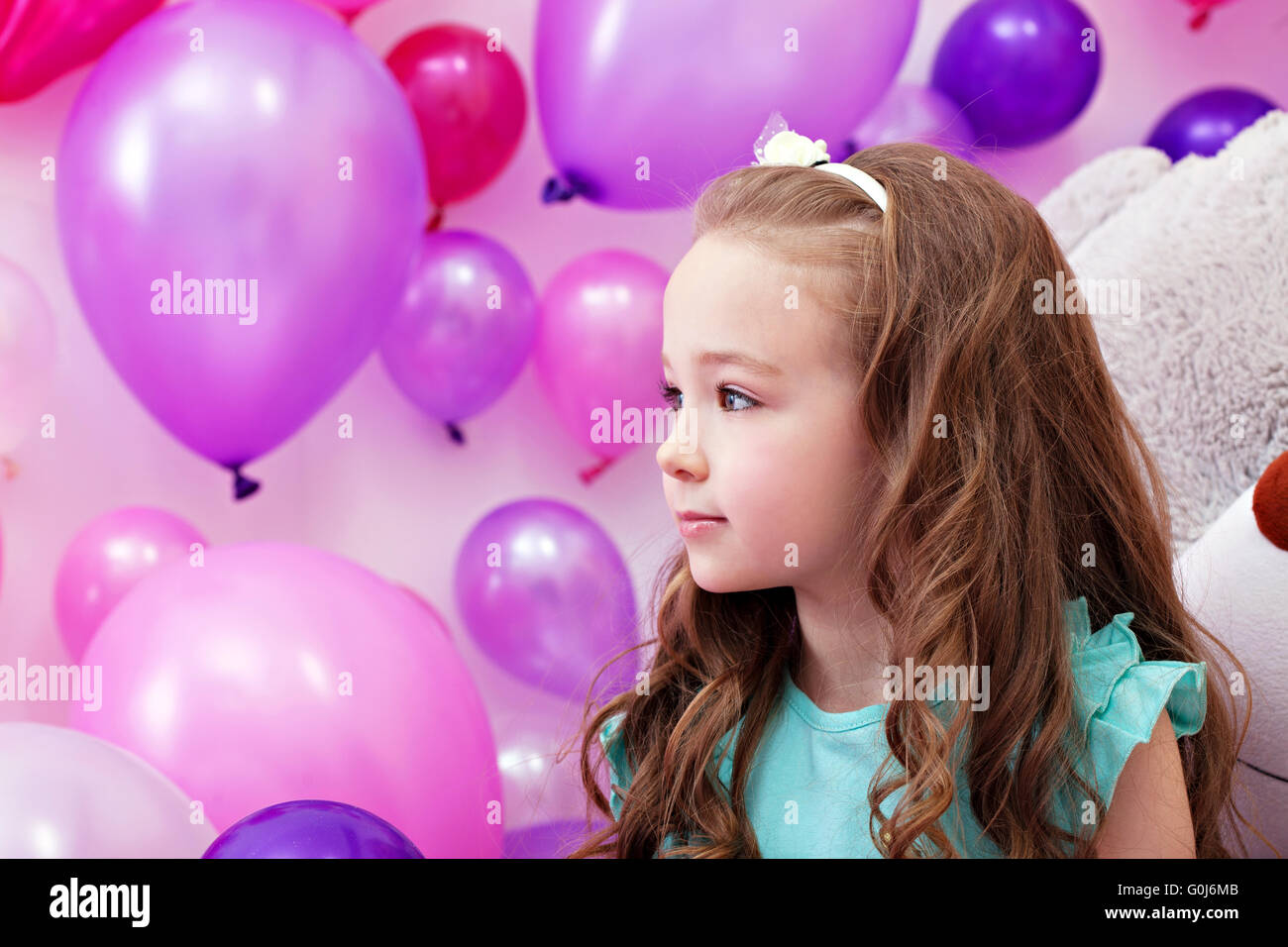 Beautiful little girl on background of balloons Stock Photo - Alamy