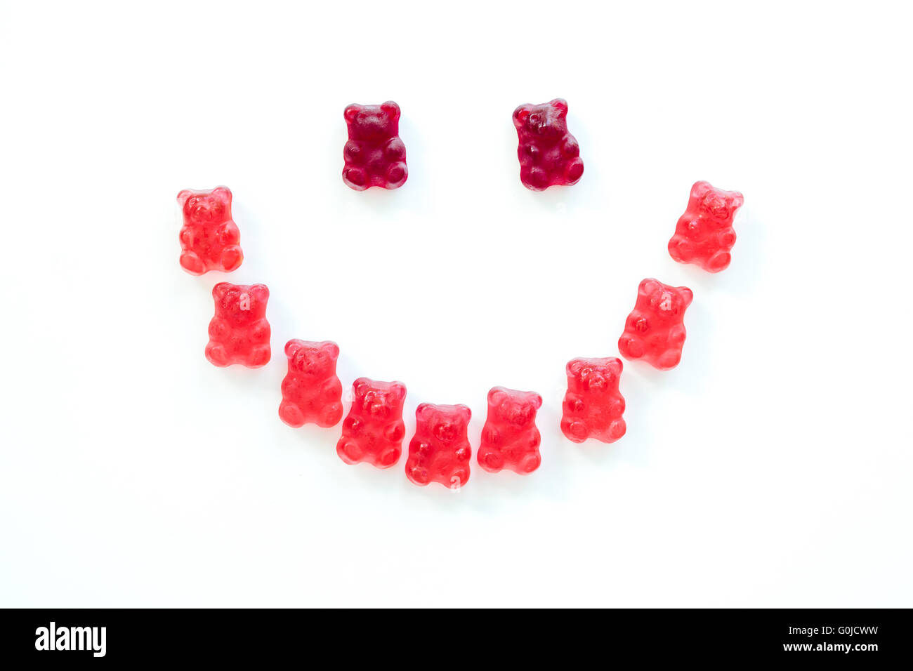 Detail of group of gummy bears forming a smiley face with isolated