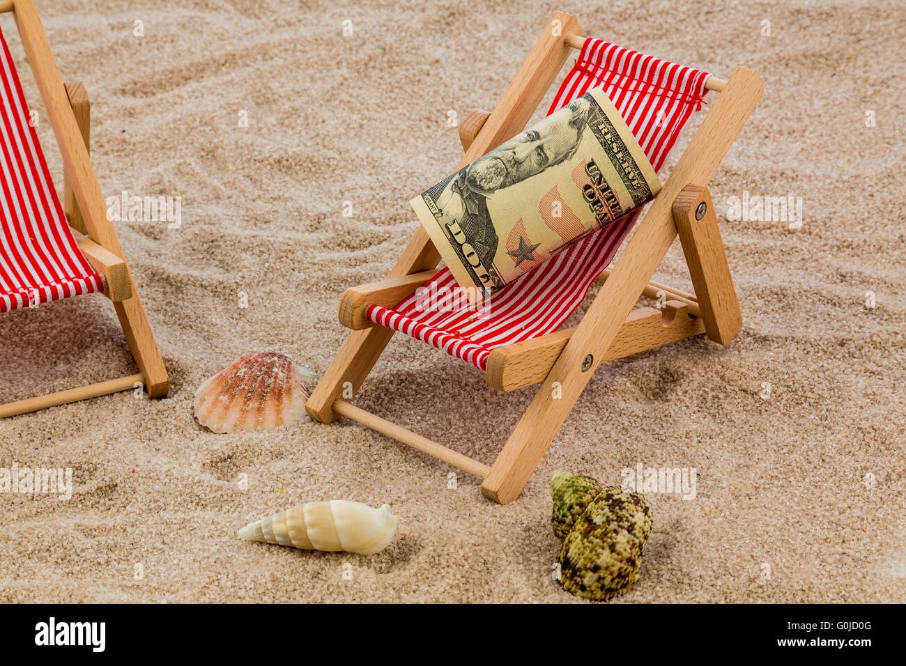 beach chair with piggy bank and dollars Stock Photo