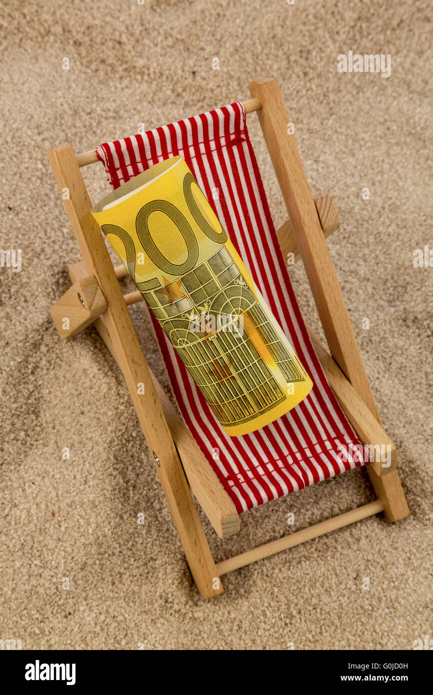 beach chair with euro banknote Stock Photo - Alamy