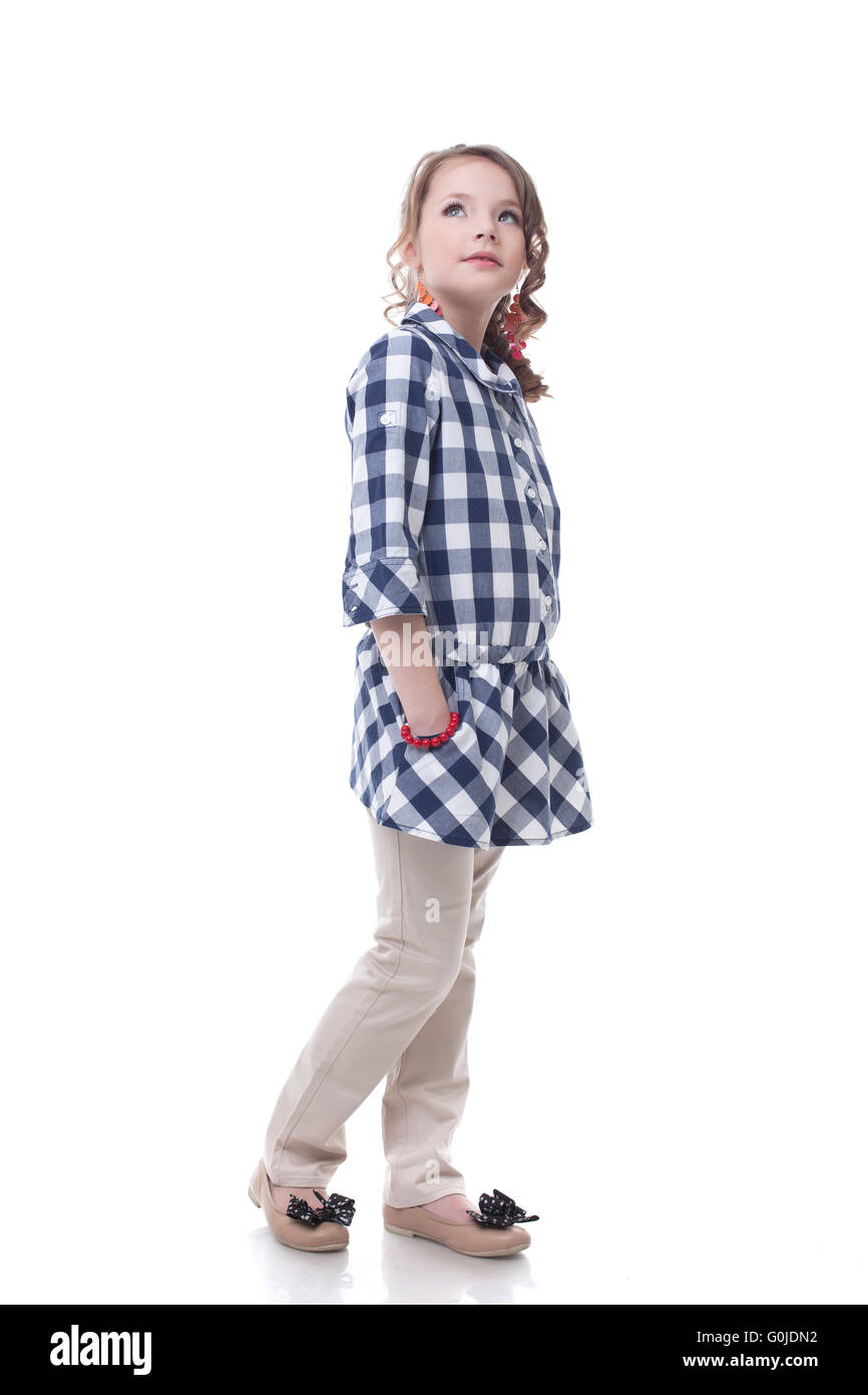 Adorable stylish little girl posing looking up Stock Photo - Alamy