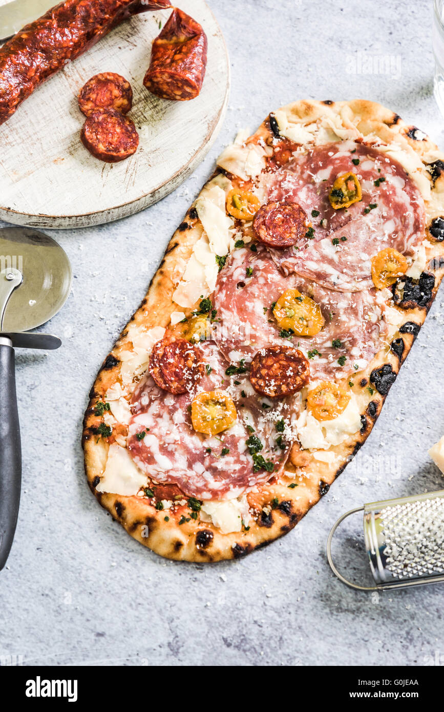 stone oven baked pizza with salami and tomatoes Stock Photo Alamy