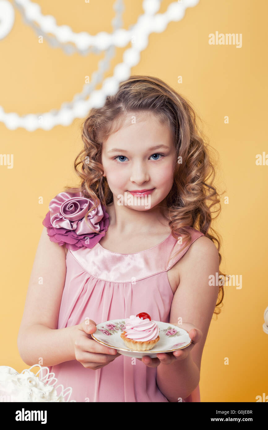 Portrait of curly elegant girl posing with cake Stock Photo Alamy