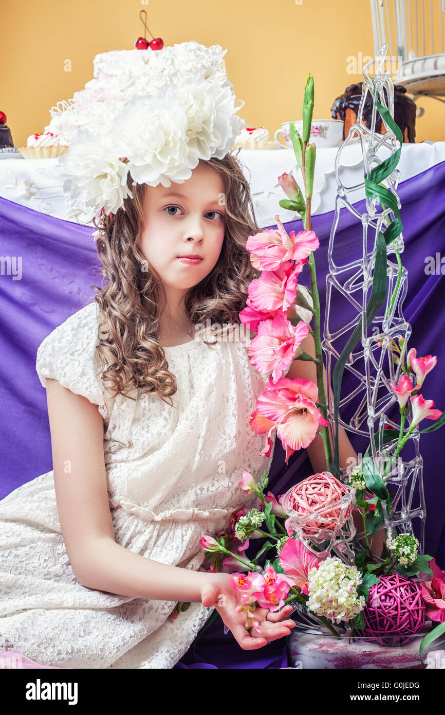 Pretty little girl posing with flower arrangements Stock Photo Alamy